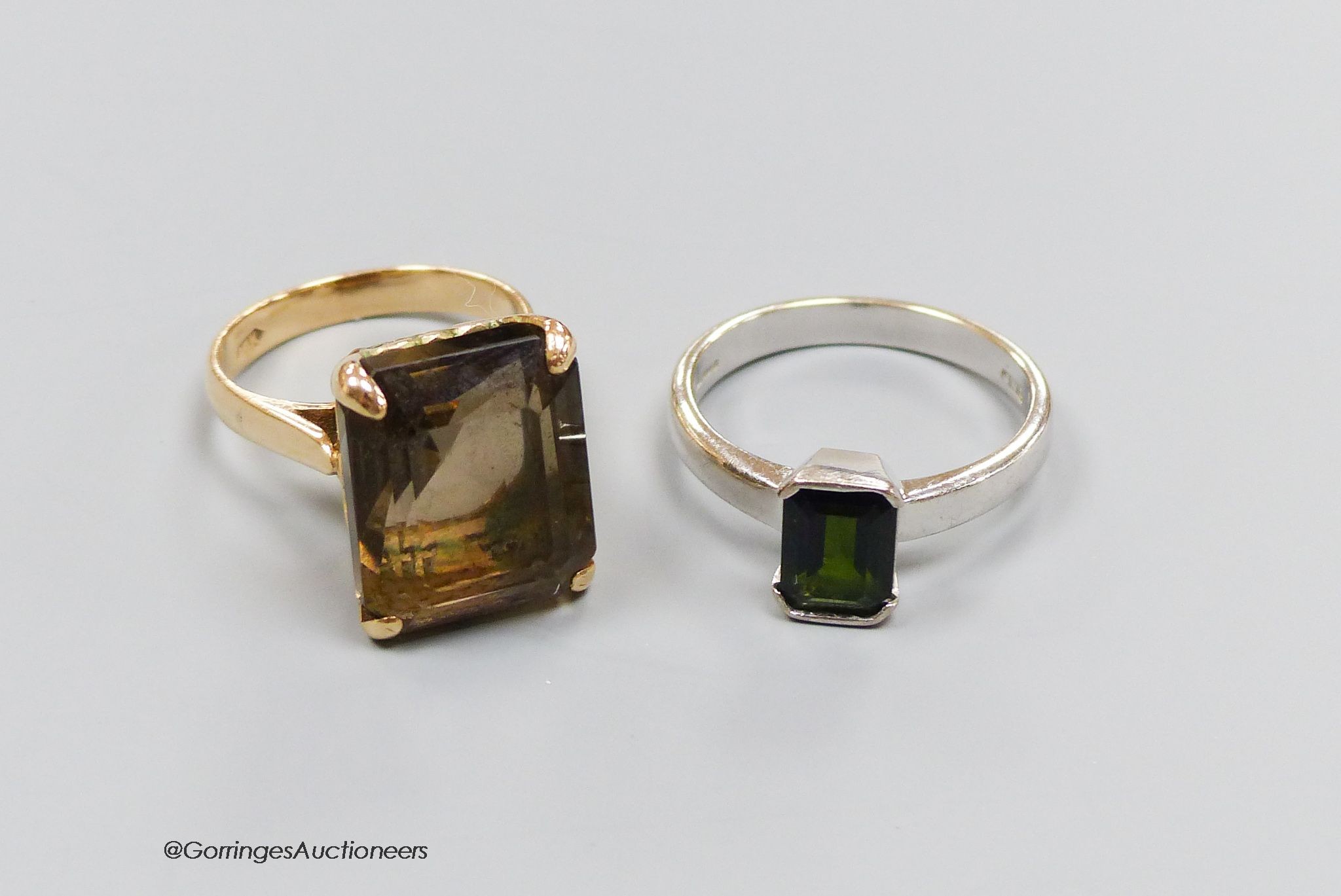 An 18ct white gold and tourmaline ring, size Q, gross 5g, and a 14k gold and smoky quartz ring, size M, gross 7g.